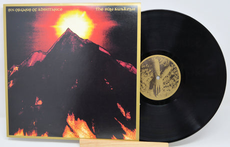 The Sun Awakens album cover with glowing sun over mountain by Six Organs of Admittance on vinyl