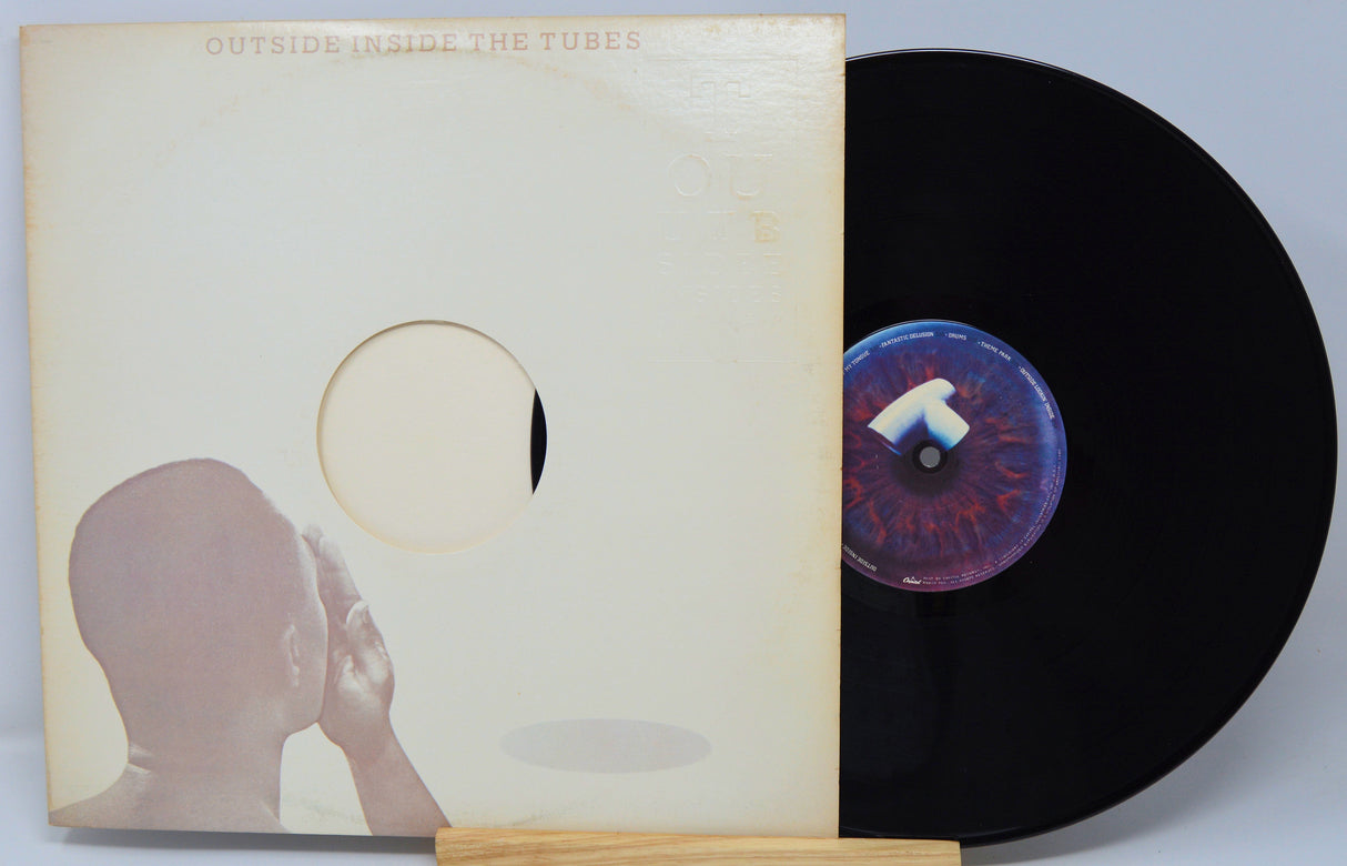 Vinyl record with cover showing a silhouette of a person and a stylized eye design.
