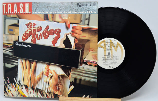 Vinyl record with cover featuring a hand holding a magazine titled 'The Tiberes'.