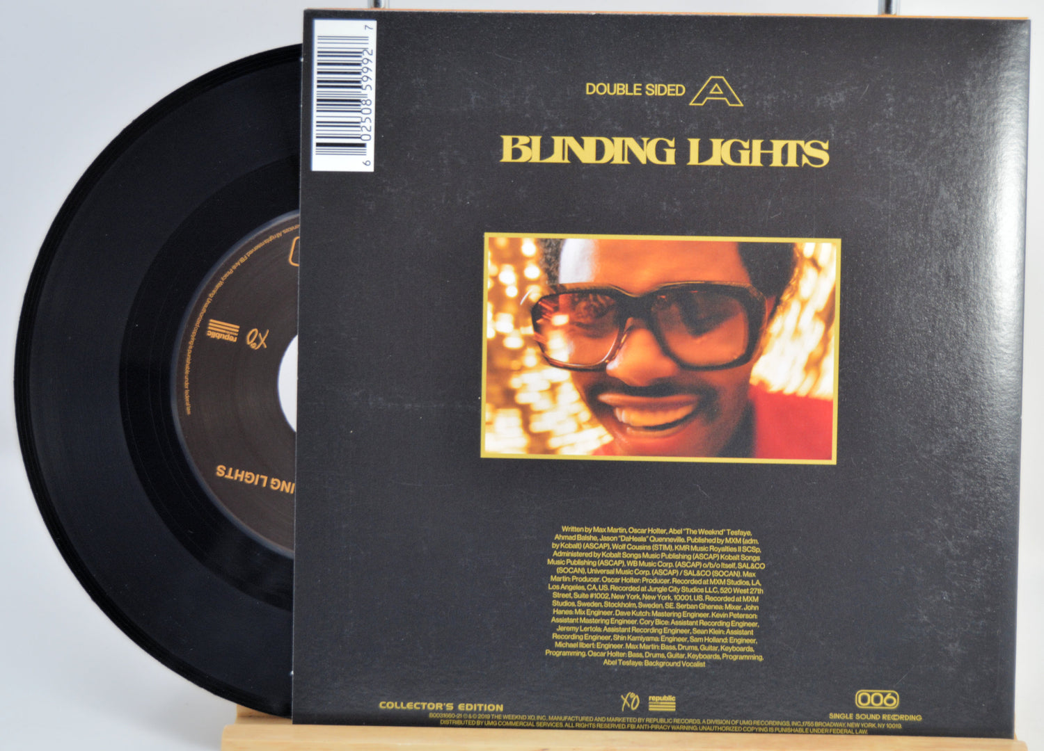 The Weeknd Vinyl record with 'Blinding Lights' album cover featuring a person with glasses and lights. Back Cover and Vinyl