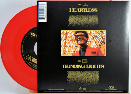 The Weeknd Vinyl record with red disc and black back cover featuring a smiling man and album title 'Blinding Lights'.