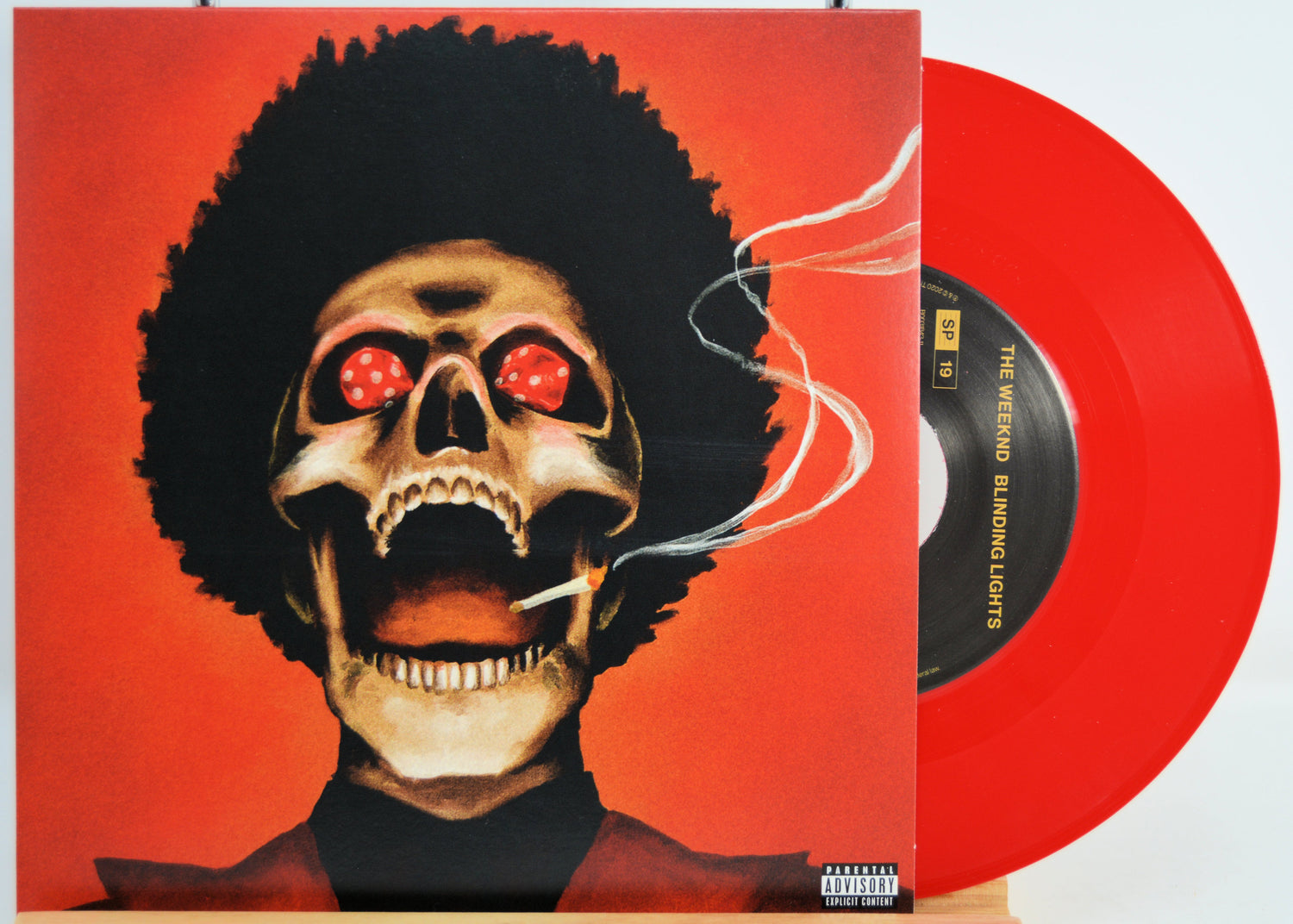 The Weeknd red Vinyl record with a cover featuring a stylized skull with red eyes and an afro on a red background.