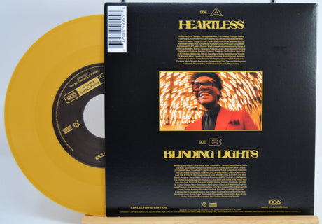 The Weekend Heartless variant #10 7 Inch Vinyl record with a black back cover featuring a person wearing sunglasses and a red jacket, and a yellow record inside.