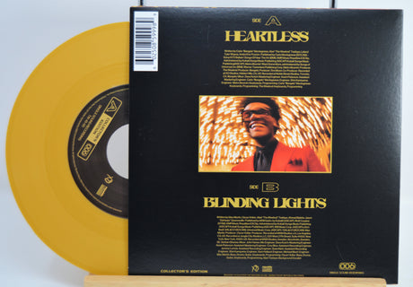The Weekend Heartless variant #12 7 Inch Vinyl record with a black back cover featuring a person wearing sunglasses and a red jacket, and a yellow record inside.
