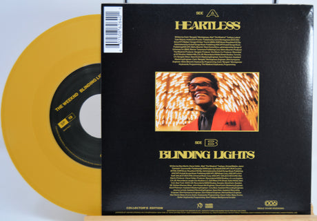 The Weekend Heartless variant #13 7 Inch Vinyl record with a black back cover featuring a person wearing sunglasses and a red jacket in front of a statue and a yellow record inside.