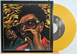 The Weekend Heartless variant #9 7 Inch Vinyl record with a black front cover featuring a person wearing sunglasses and a red jacket, and a yellow record inside.