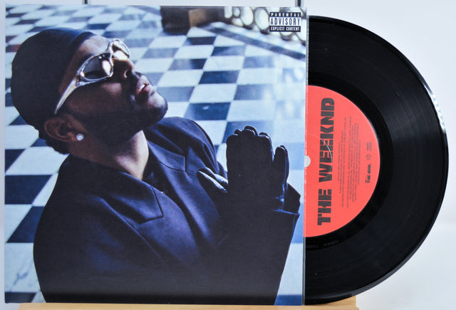 7 Inch Vinyl record front cover featuring 'The Weeknd' on a checkered floor background.