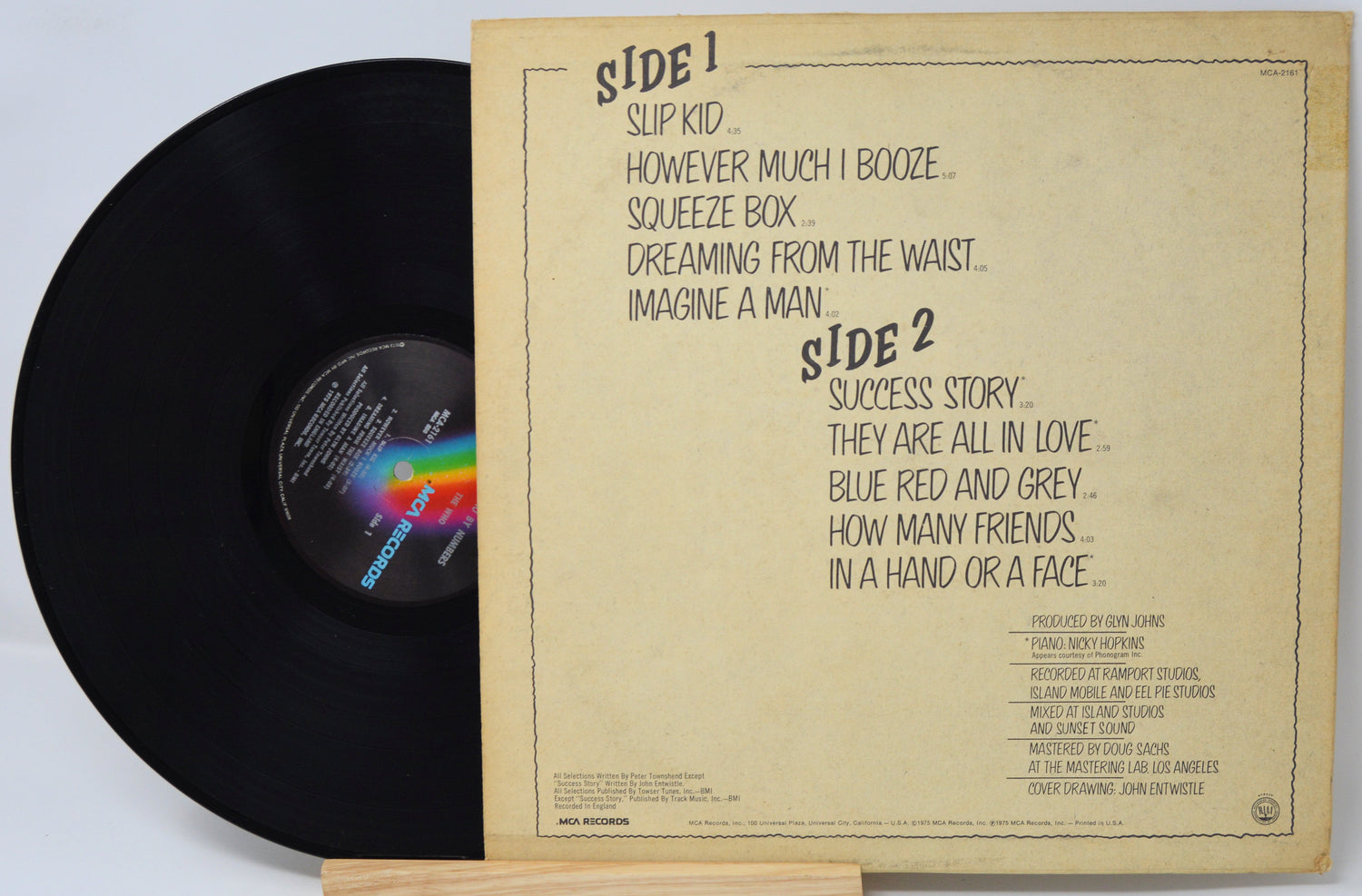 Vinyl record with a brown label on a light gray background