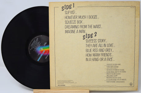 Vinyl record with a brown label on a light gray background