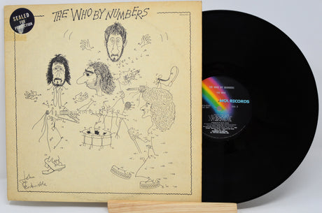 Vinyl record with cover featuring illustrations and 'The Who by Numbers' text