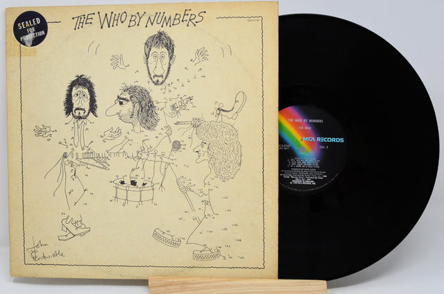 Vinyl record with cover featuring illustrations and 'The Who by Numbers' text
