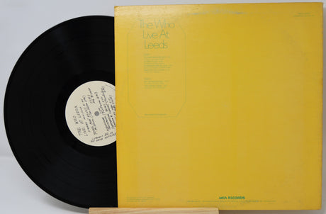 Vinyl record with yellow cover and black disc on a white background
