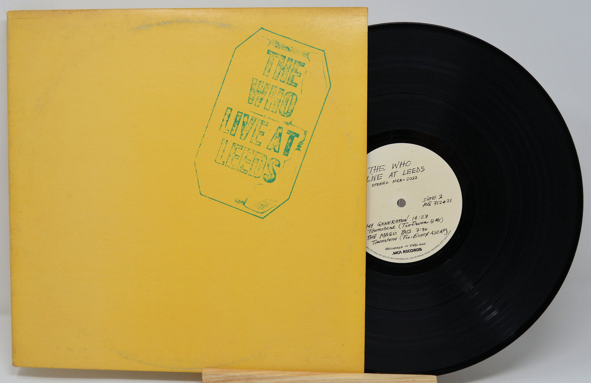 Vinyl record with yellow cover and black disc on a gray background