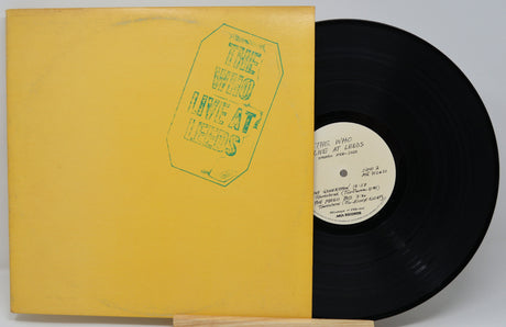 Vinyl record with yellow cover and black disc on a gray background