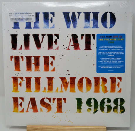 The Who - Live At The Fullmore East 1968 vinyl record album cover, sealed in plastic and displayed on a wooden stand against a white background.