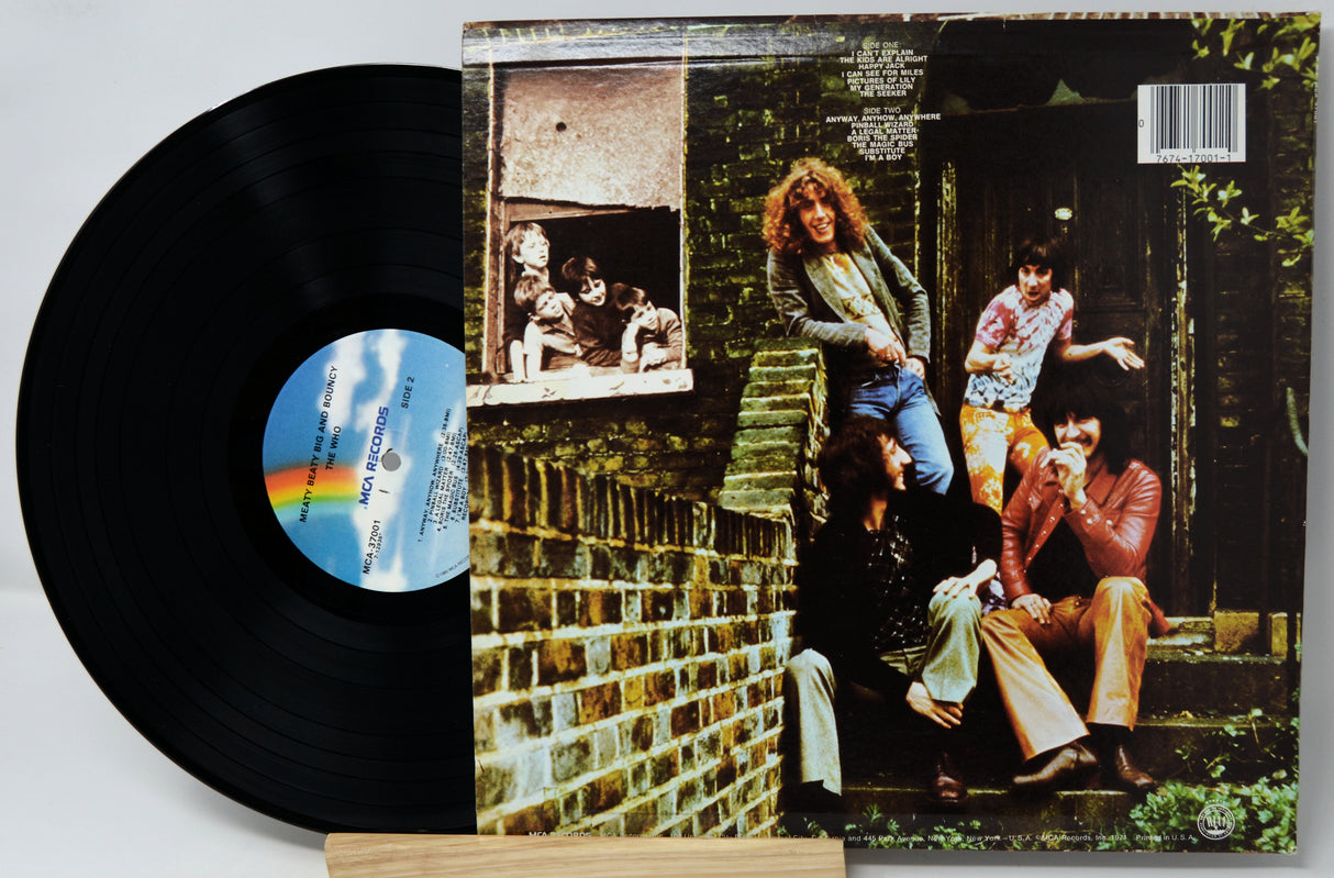 Vinyl record with a colorful label and cover featuring people sitting on steps.