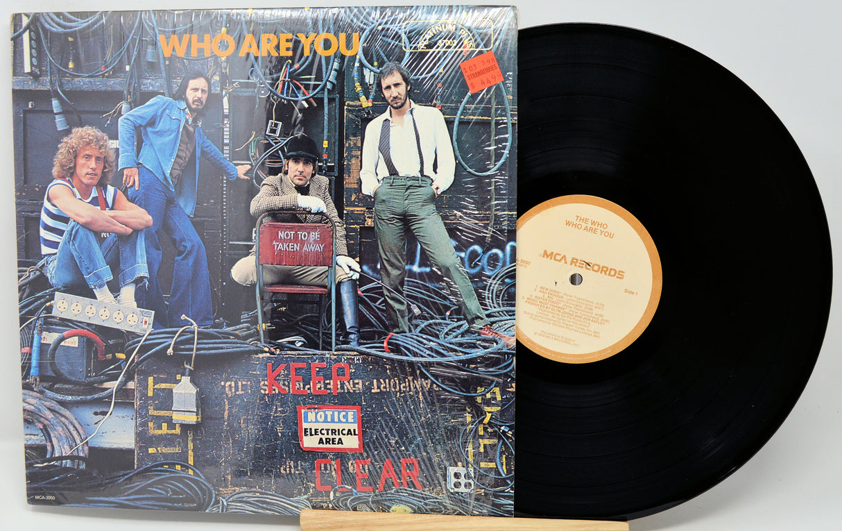 Vinyl record with cover featuring a band and text 'Who Are You' on a white background