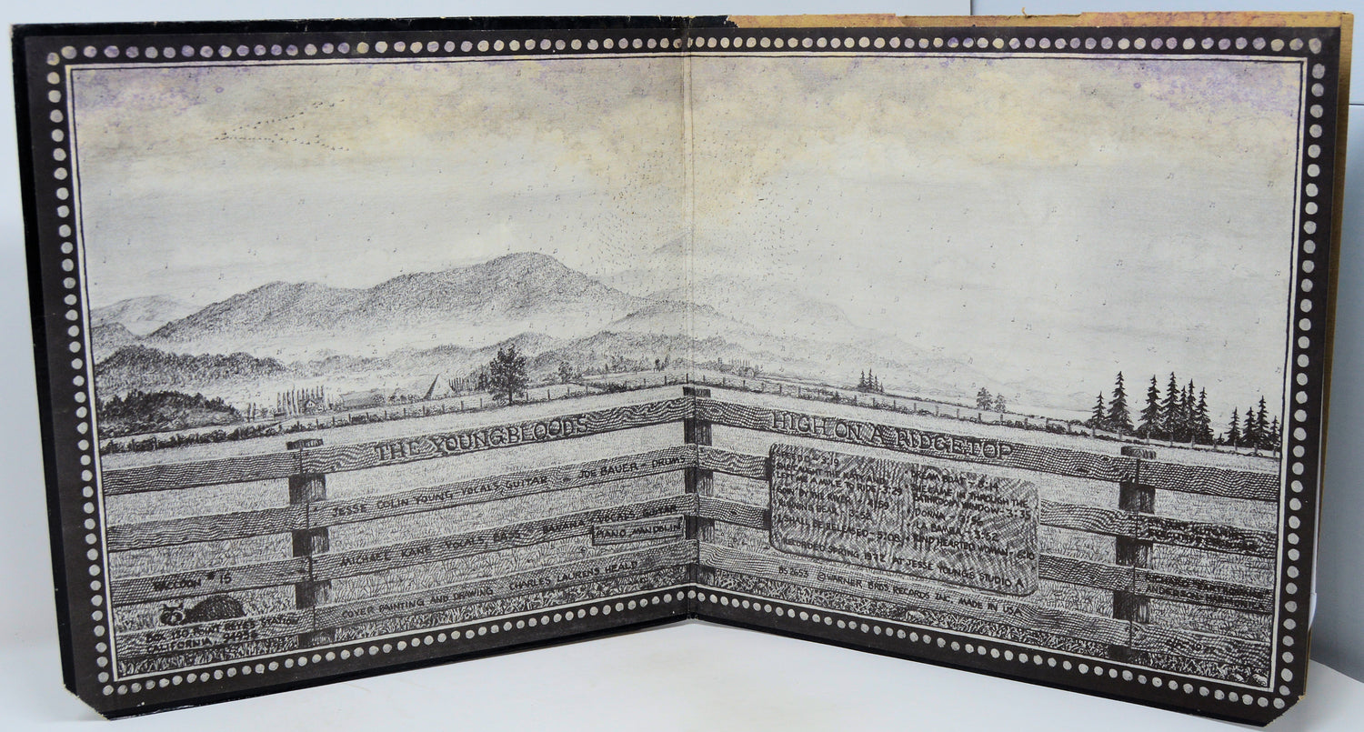 Open book with printed landscape and text on a white background