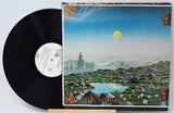 Vinyl record with a landscape cover featuring mountains and a lake.