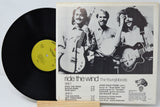 Vinyl record with a cover featuring a band and album details on a white background
