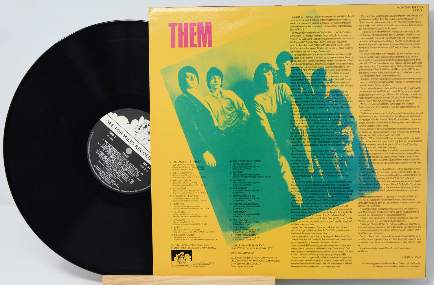 Vinyl record with yellow cover featuring a band illustration and text.