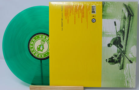 Green vinyl record with a yellow label and album cover featuring a person with a surfboard.