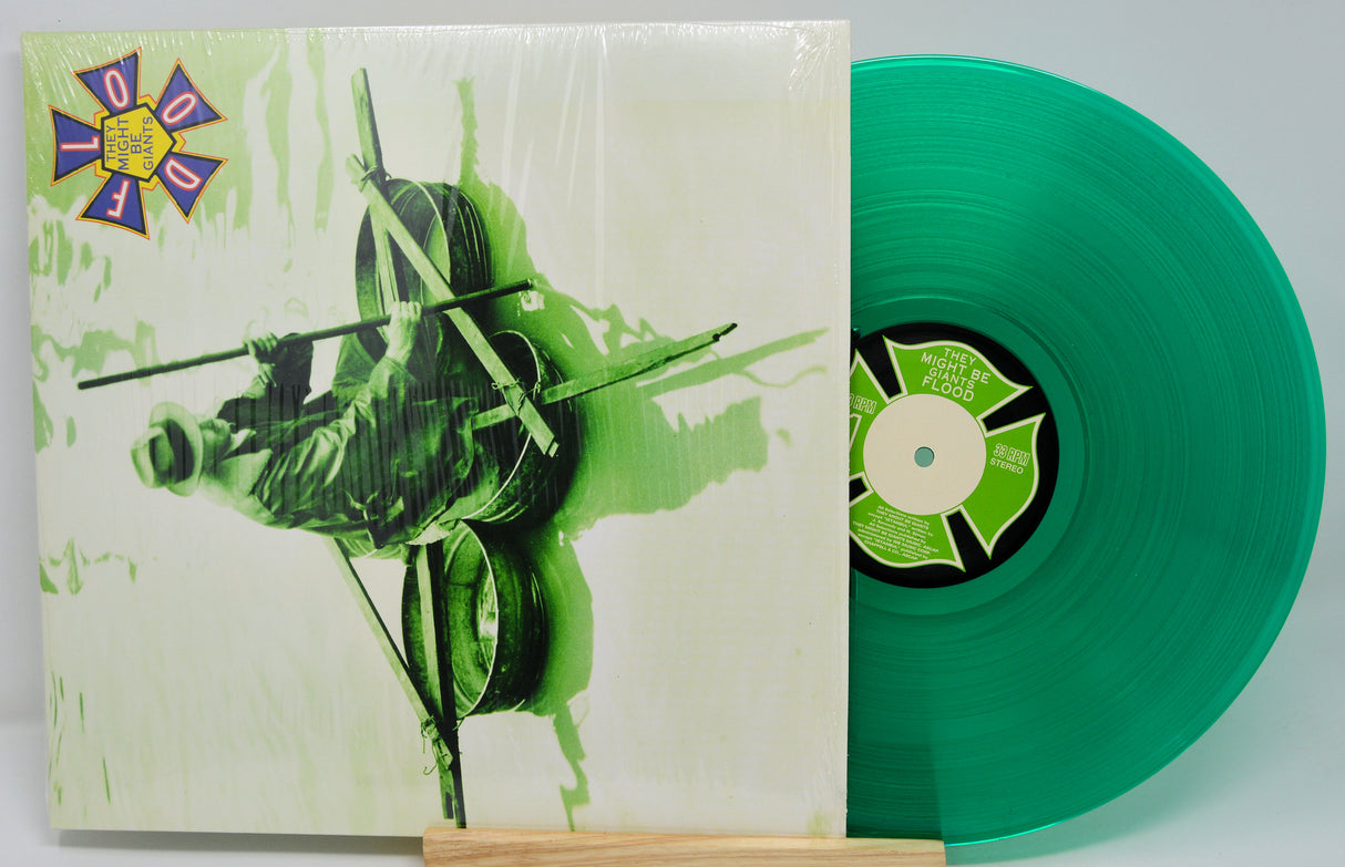 Green vinyl record with matching cover featuring a stylized illustration.