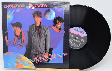 Vinyl record with cover featuring 'Thompson Twins' on a white background