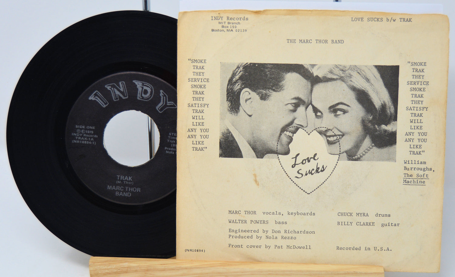 Vinyl record and its cover with a couple's portrait and text on a white background