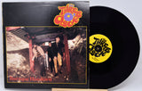 Vinyl record and cover with 'The Three Clocks' band on a white background