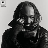 Black and white album cover with a phote of Thundercat wearing a leather jacket and holding a phone to their ear, featuring Brainfeeder Music Records logo.