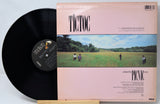 Vinyl record with 'Tictoc' album cover showing people in a field