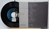 Vinyl record with label and text on a white background