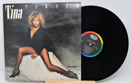 Vinyl record with cover featuring a woman, likely Tina Turner, on a gray background.