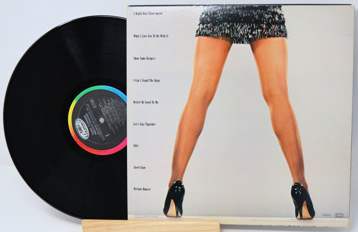 Vinyl record with a cover featuring a person in high heels and a short dress.