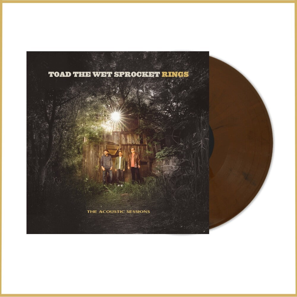 Vinyl record with cover featuring a group of people in front of a cabin in the woods, titled 'Toad the Wet Sprocket Rings'.