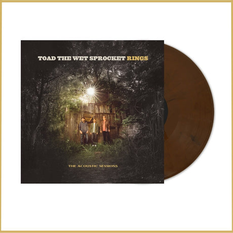 Vinyl record with cover featuring a group of people in front of a cabin in the woods, titled 'Toad the Wet Sprocket Rings'.