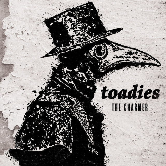 Black and white album cover with a masked bird figure and 'toadies' and 'The Charmer" text on a textured background.