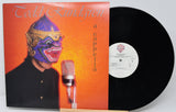 Vinyl record with a colorful album cover featuring a person in a mask and microphone.