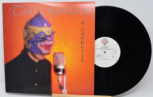 Vinyl record with a colorful album cover featuring a person in a mask and microphone.