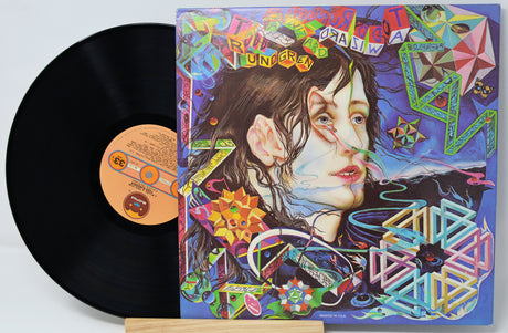 Vinyl record with a colorful album cover featuring a stylized portrait and abstract designs.