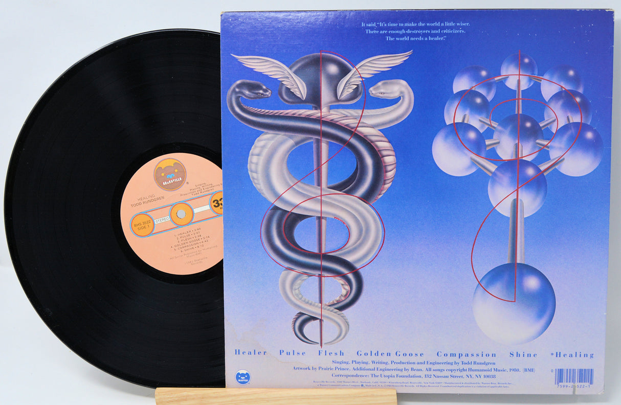 Vinyl record with a blue and white cover featuring abstract designs and text.