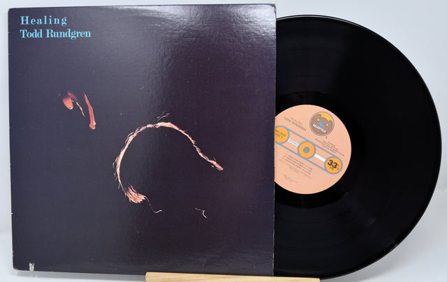 Vinyl record with cover featuring colorful artwork and text