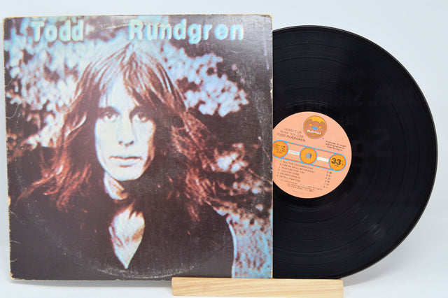 Vinyl record with cover featuring a portrait and album details on a light blue background
