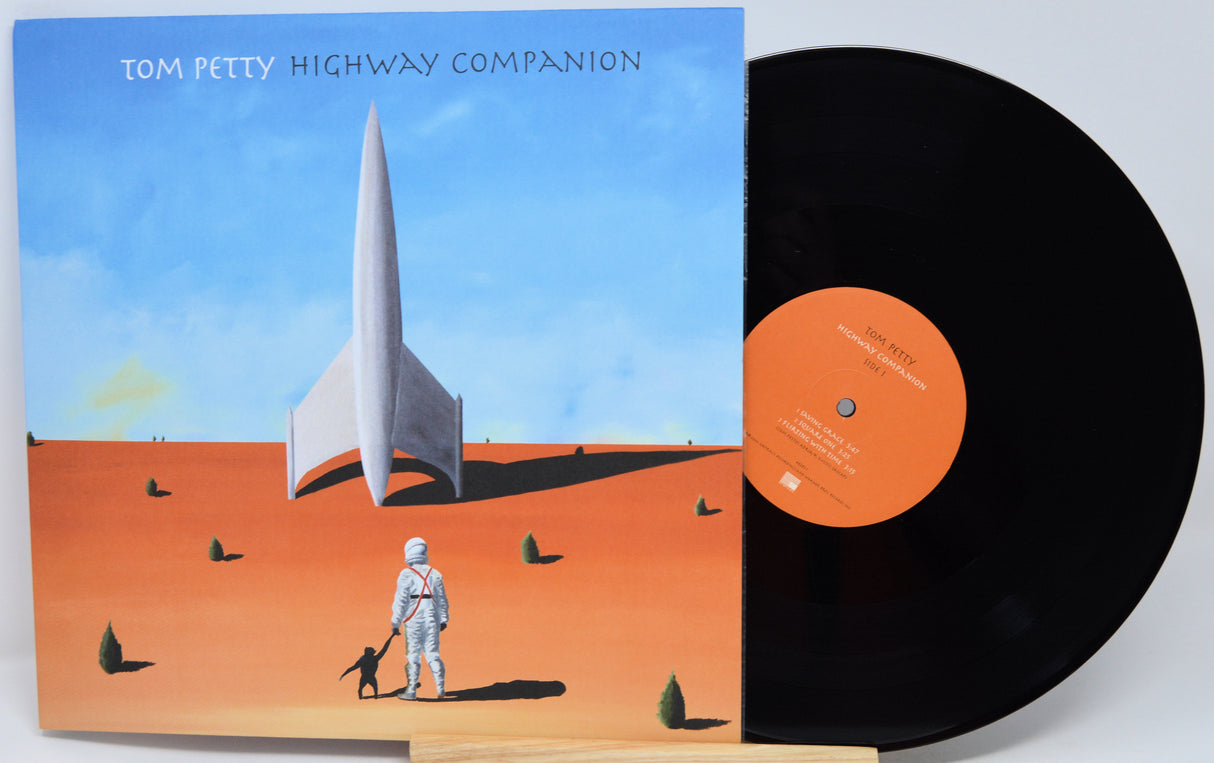 Tom Petty's 'Highway Companion' vinyl record album, showing the illustrated black-and-white cover sleeve with a black record partially pulled out, set against a plain light background.