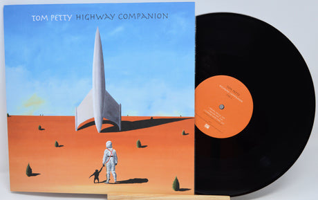 Tom Petty's 'Highway Companion' vinyl record album, showing the illustrated black-and-white cover sleeve with a black record partially pulled out, set against a plain light background.
