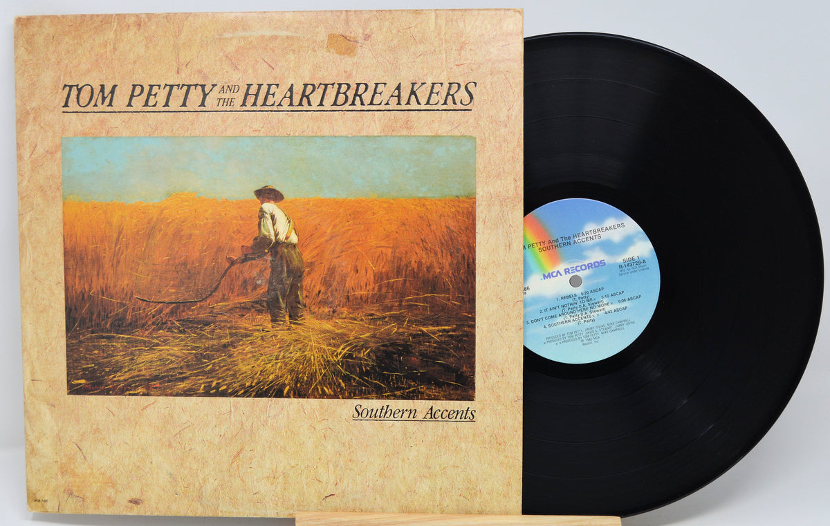 Tom Petty and the Heartbreakers 'Southern Accents' vinyl record LP with the album cover in front and the black record partially pulled out, showing the blue label.