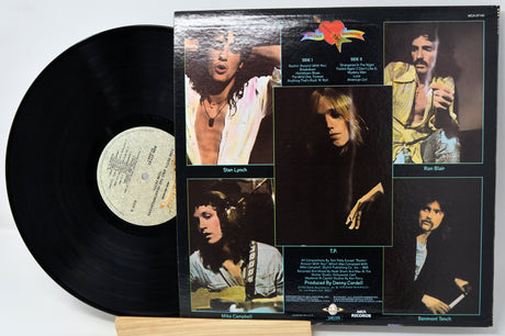 Vinyl record with a colorful cover featuring images of a band member and text.