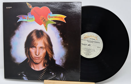 Vinyl record with cover featuring a person and colorful design