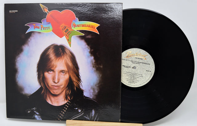 Vinyl record with cover featuring a person and colorful design